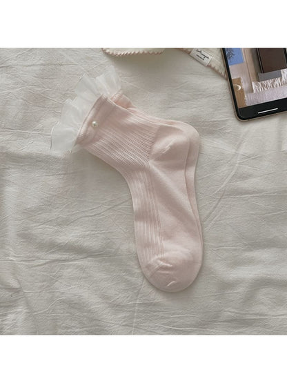 Model wearing Rufia sheer ruffle trim crew socks with skirt