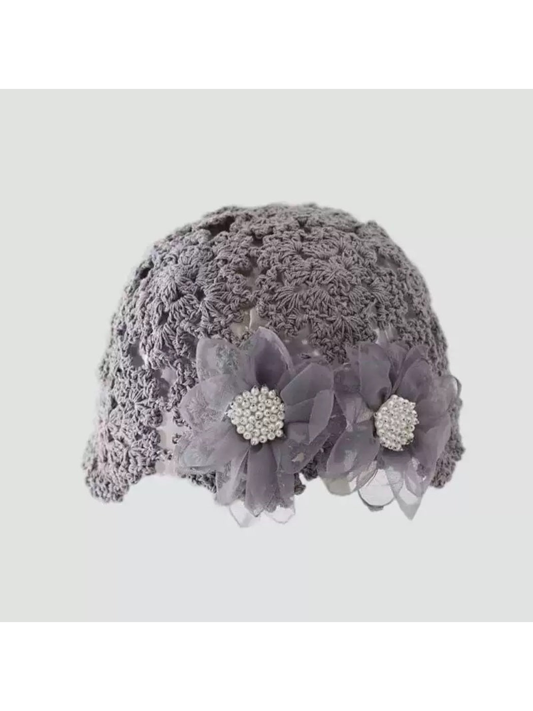 Back view of Haila openwork hat showing flower embellishment and knit craftsmanship
