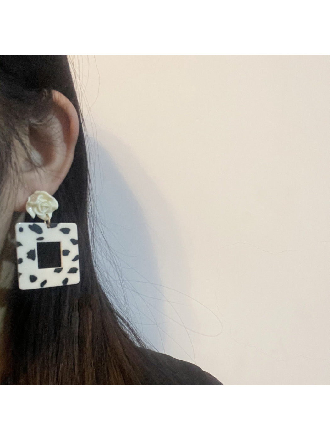 Close-up of Earwish Cow Print Rose Earrings showing textured rose and cow print design