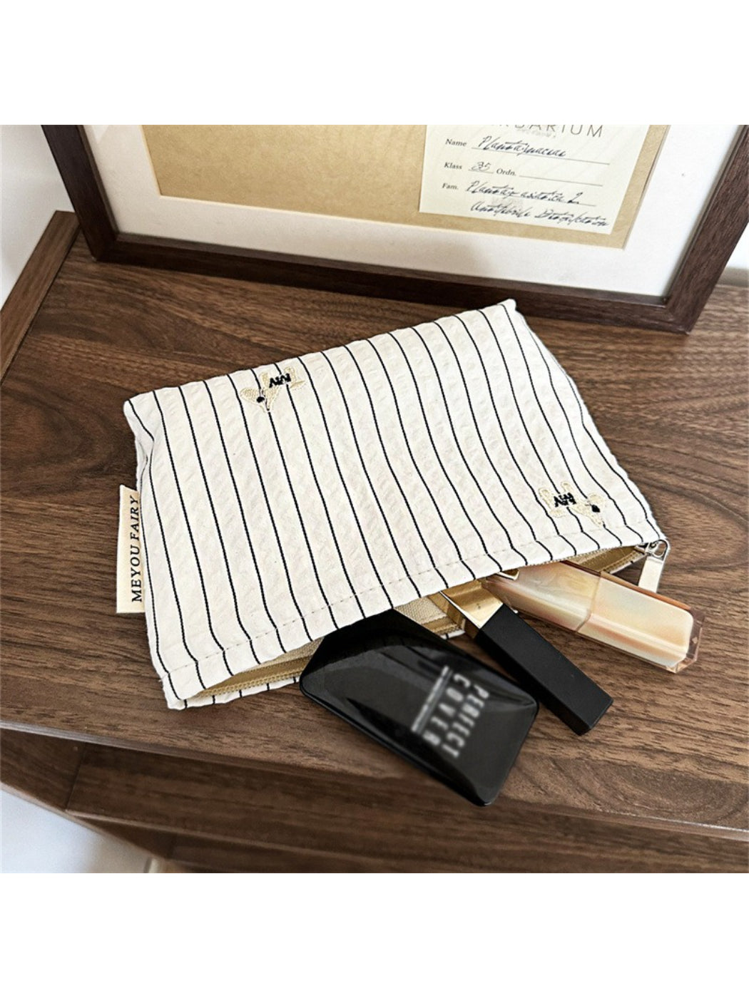 Cosbai Classic Pinstripe Cosmetic Organizer packed with various cosmetics and travel essentials