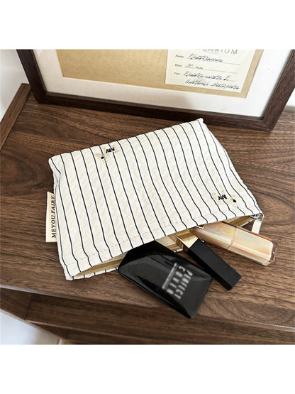 Cosbai Classic Pinstripe Cosmetic Organizer packed with various cosmetics and travel essentials
