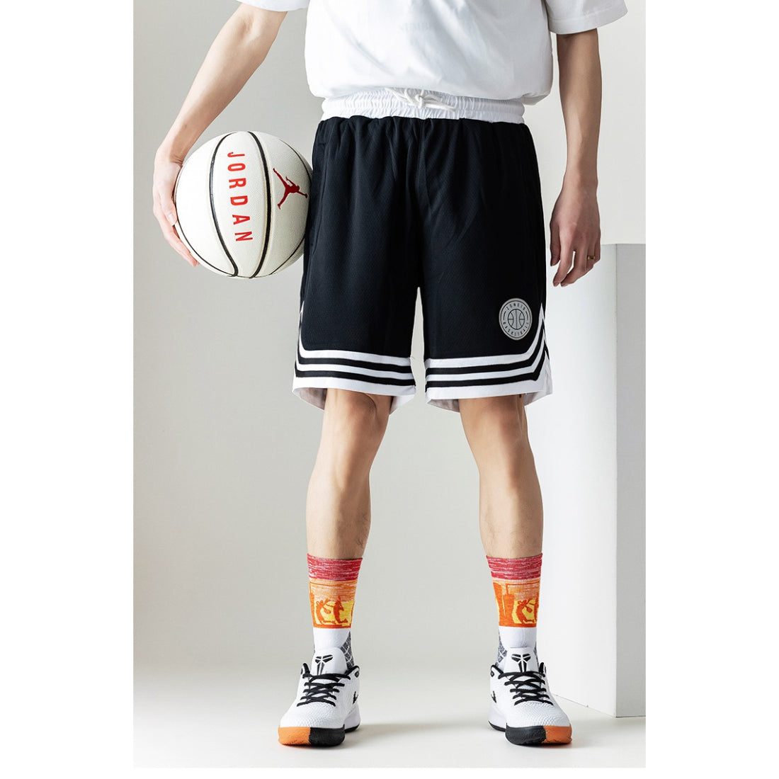 Model wearing Rufia color block sport crew socks with casual sneakers
