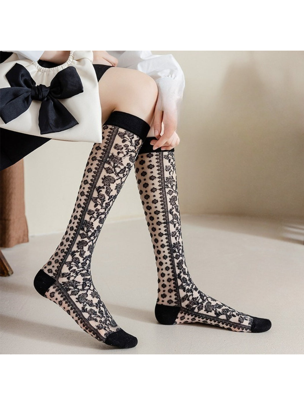 Close-up of Rufia lace floral knee high sock on a model's leg