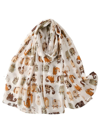 Whimsical kitty pattern scarf folded to show colorful cat illustrations on soft fabric