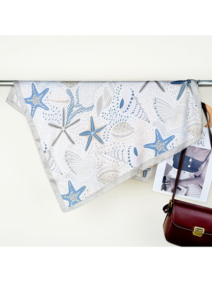 Scarvii Seaside Motif Square Scarf draped over a chair showing full pattern