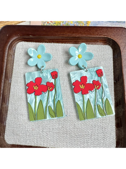 Earwish Painted Flower Drop Earrings worn on a model's ear with natural lighting