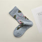 Rufia mesh floral mid-calf socks worn with shoes, showing floral mesh detail above shoe line