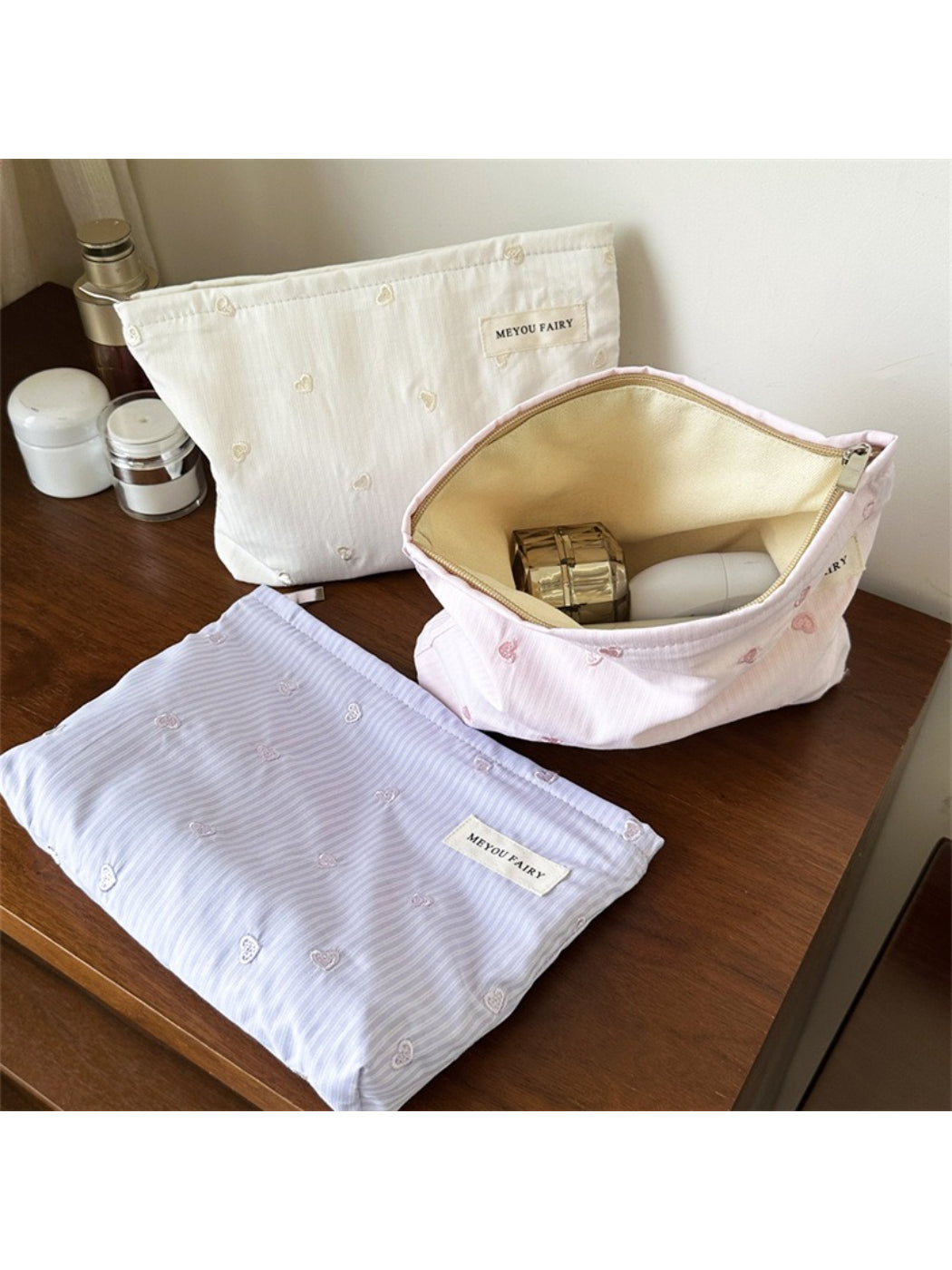 Cosbai makeup organizer bag displayed alongside travel essentials