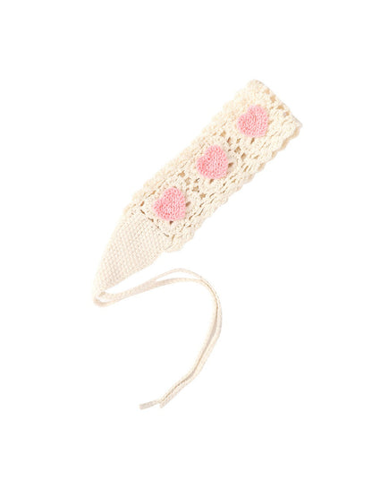 Scarvii crochet heart tie headband tied in a bow with visible heart motif