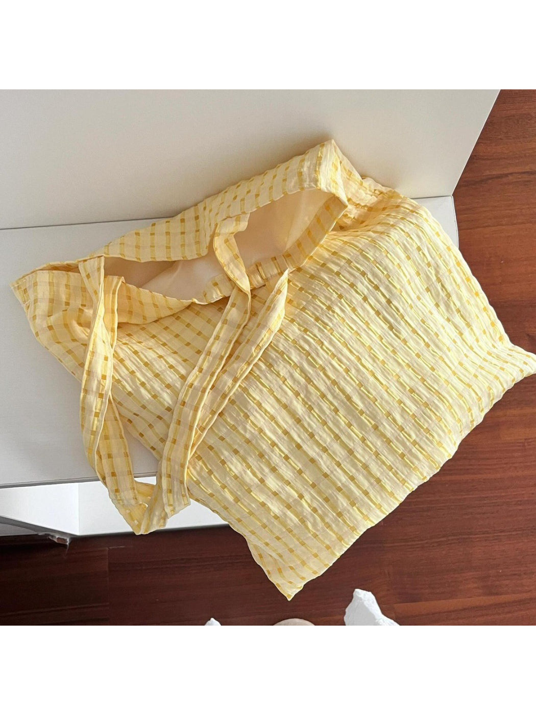 Cosbai tote placed on wooden surface, emphasizing lightweight and flexible material