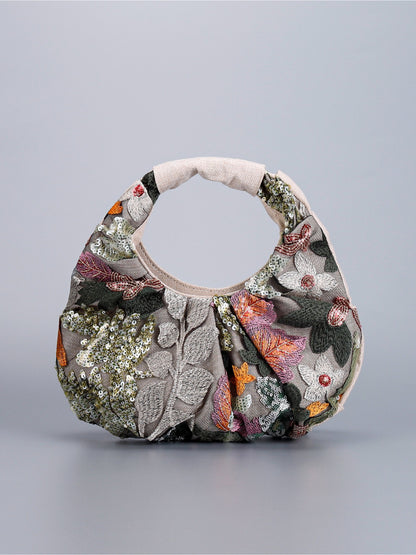 Cosbai hobo bag displayed on a model's shoulder with floral sequin pattern