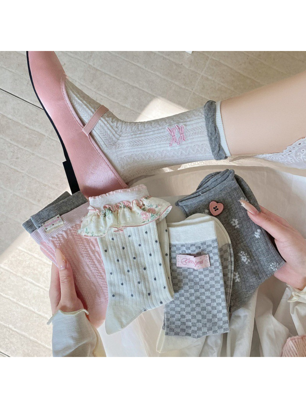 Pair of Rufia Romantic Everyday Crew Socks in soft pink with subtle heart pattern