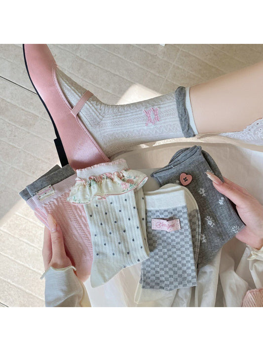 Pair of Rufia Romantic Everyday Crew Socks in soft pink with subtle heart pattern