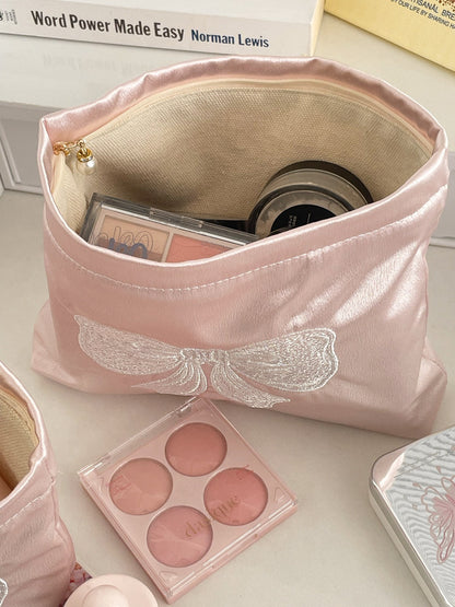 Cosbai cosmetic pouch in soft pink with a large decorative bow on front