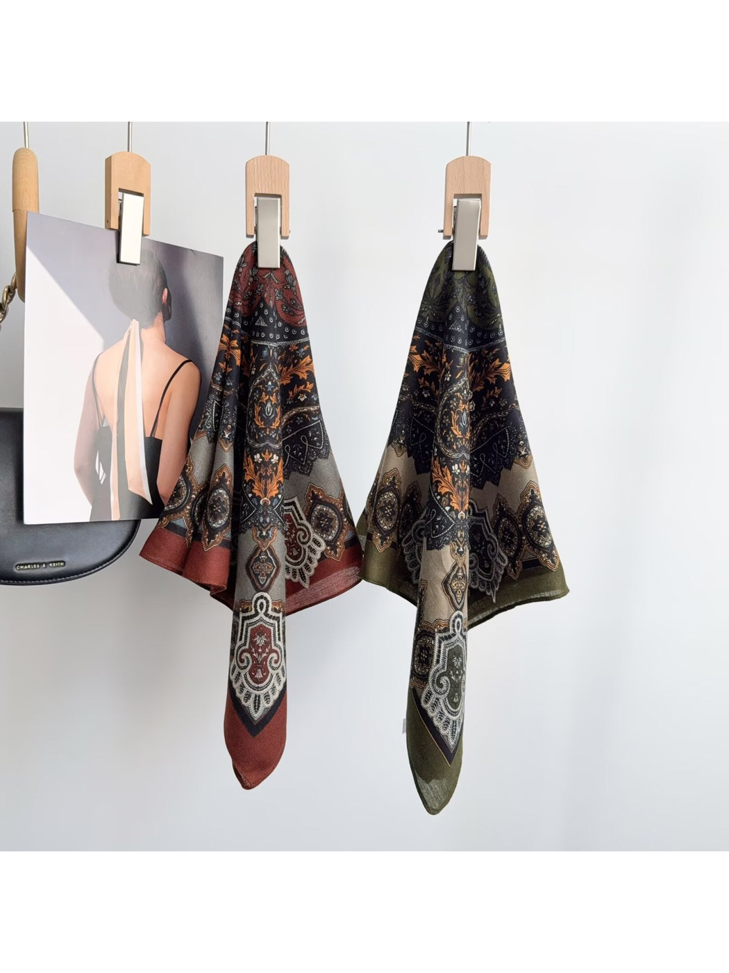 Army Green and red paisley scarves displayed on hangers