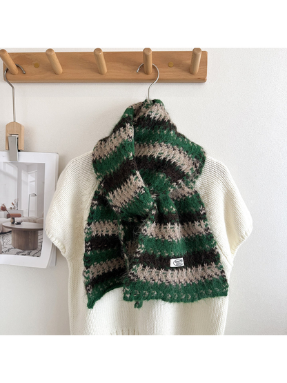 Green, black, and beige striped scarf draped on a white display form