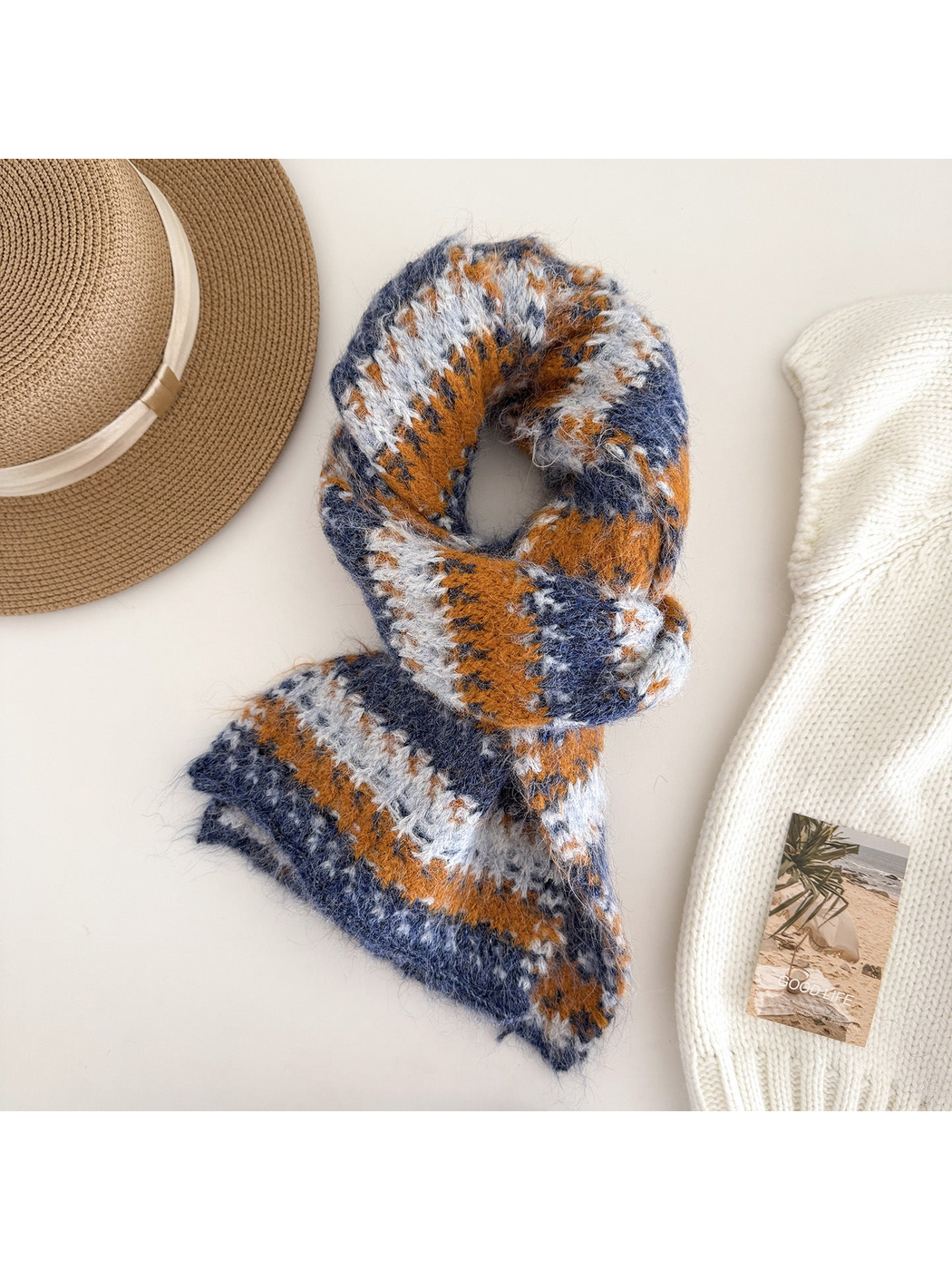 Orange striped scarf on a white display form