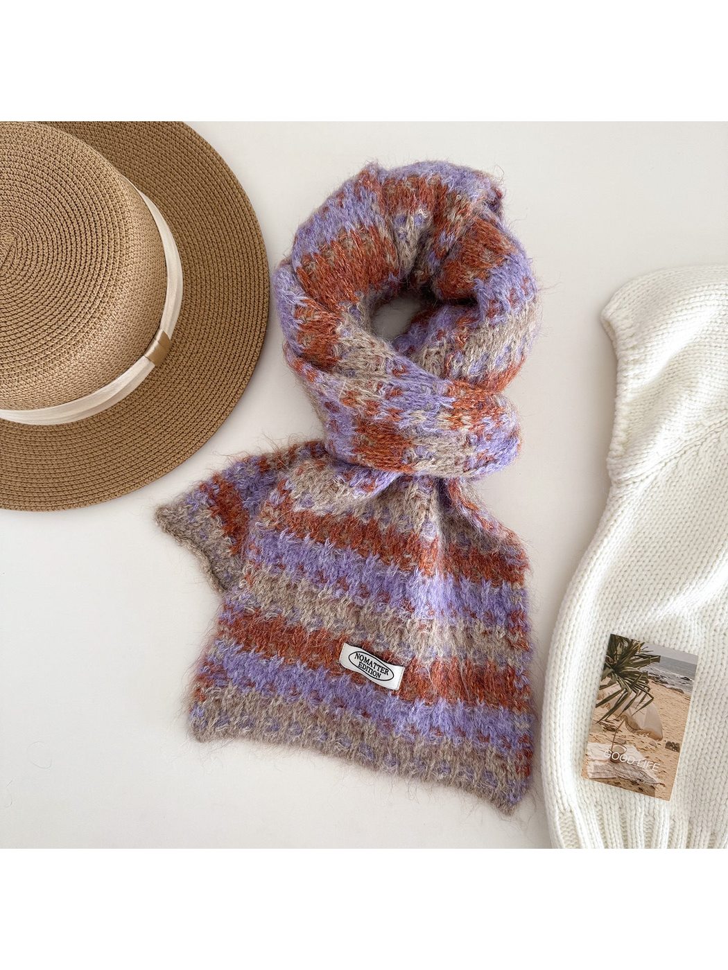 Purple striped scarf on a white display form