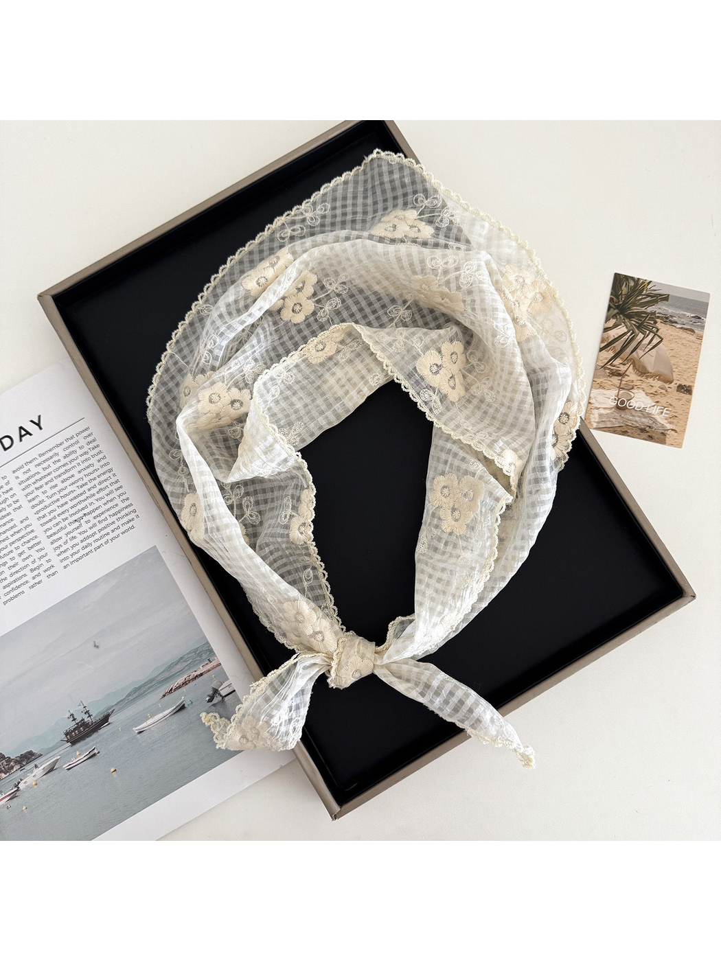 Ivory floral-check triangle scarf arranged in a loop