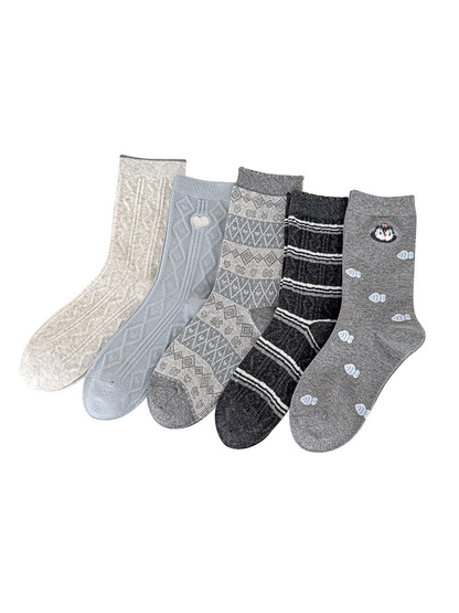 Waves, Heart, Geometric, Stripes, and Fish socks displayed together on a white background.