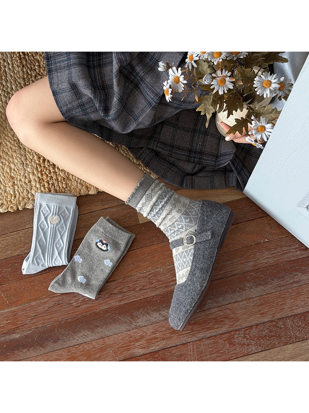 Gray Geometric socks worn with a buckle shoe, with Heart and Fish socks arranged nearby.