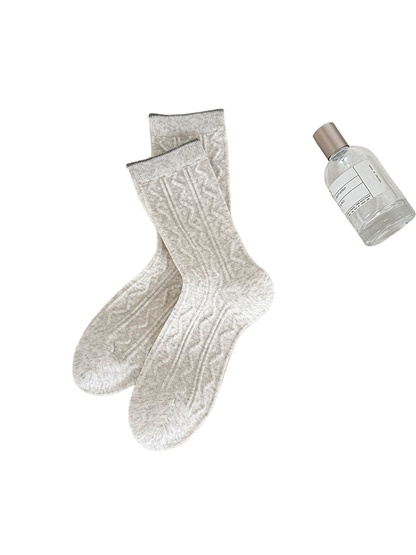 Ivory Waves socks with raised wavy columns and narrow dark cuff edges.