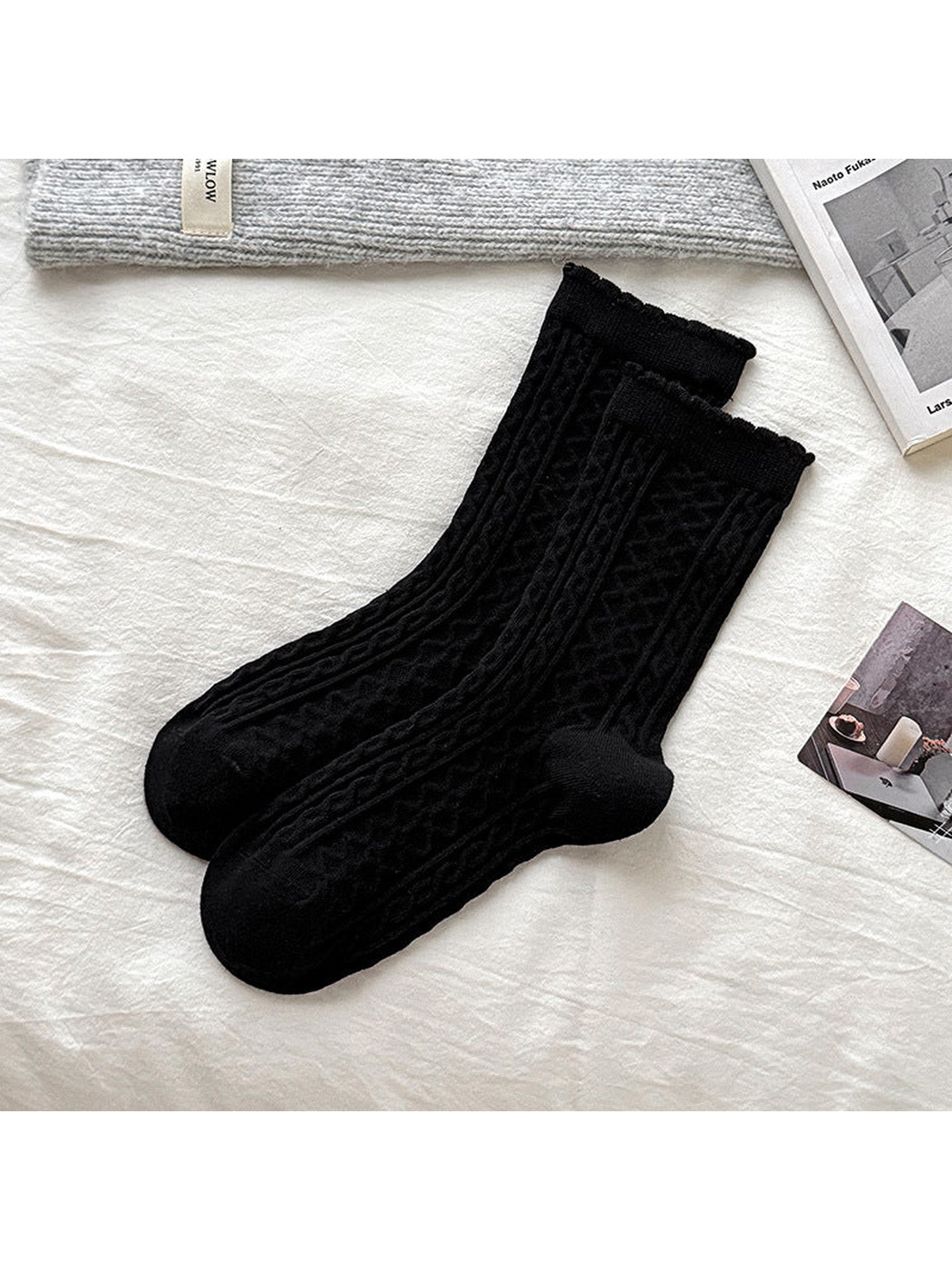 Black cable-knit socks with ribbed cuffs