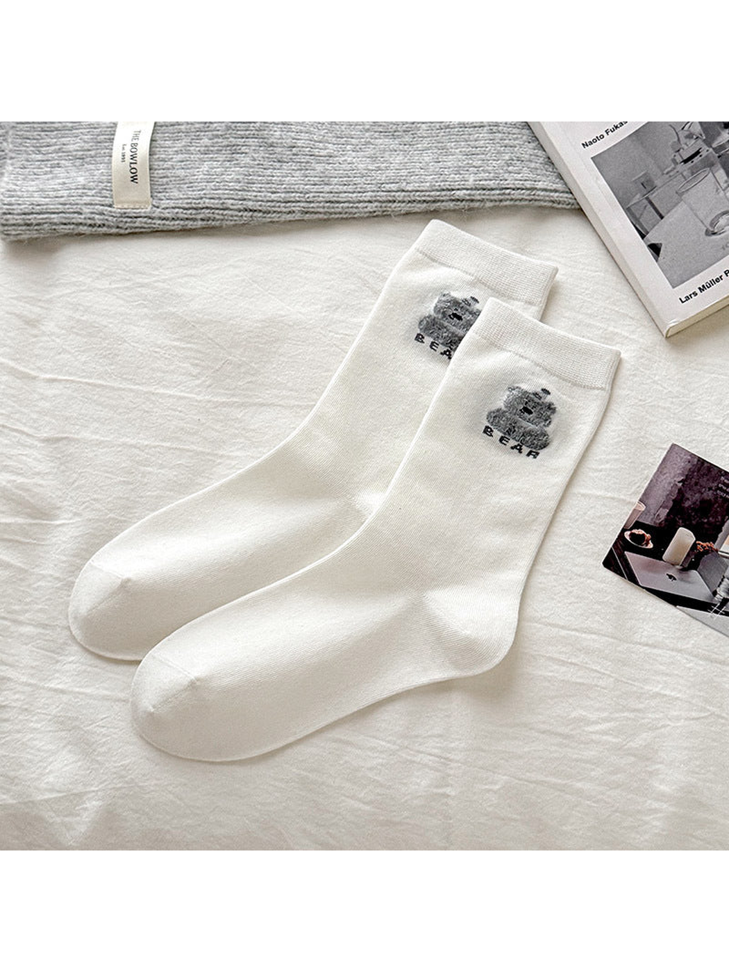 White socks with a gray bear motif