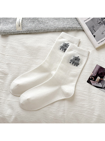 White socks with a gray bear motif