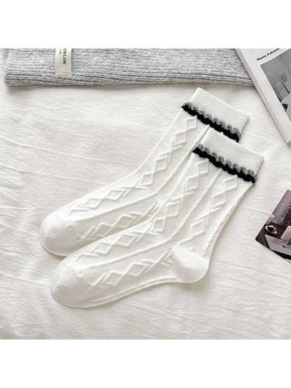 White socks with raised diamond texture and black scalloped cuffs