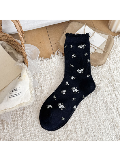 Black Floral crew sock with floral motifs and a scalloped cuff