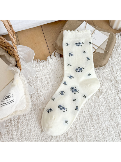 White Floral crew sock with floral motifs and a scalloped cuff