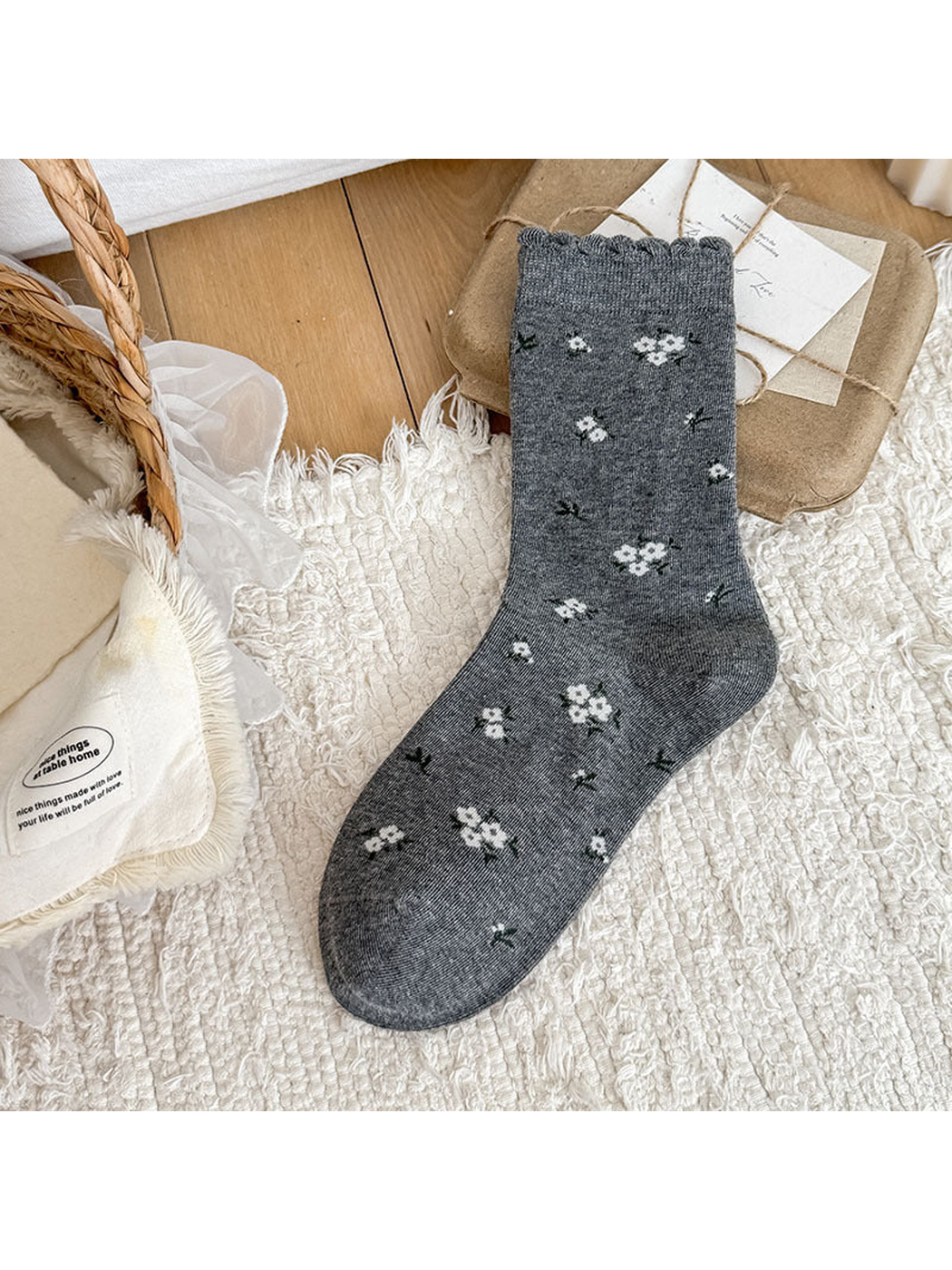 Gray Floral crew sock with floral motifs and a scalloped cuff