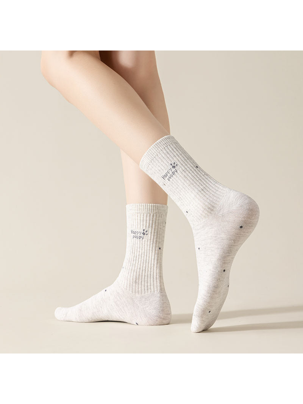 Light socks worn on legs, including a dotted Happy Puppy design