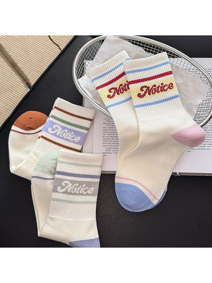 Five color-variant crew socks arranged together