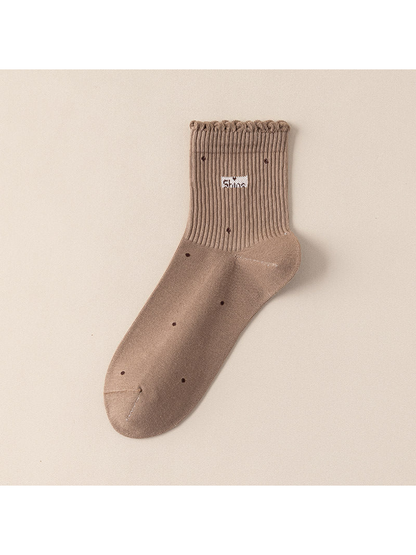 Khaki crew sock with scattered dot motifs and a scalloped ribbed cuff