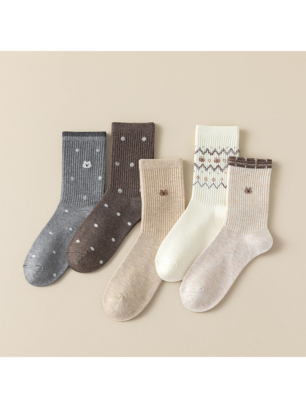 Five crew sock styles arranged together, with dots, cat motifs, stripes and zigzag bands