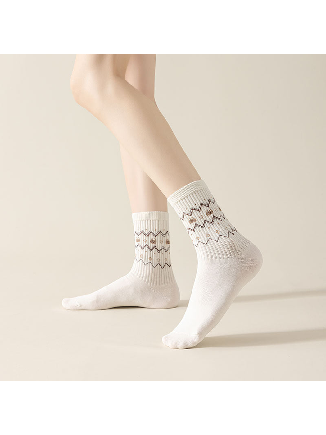 Zigzag crew socks worn with one heel raised, showing the patterned ribbed legs