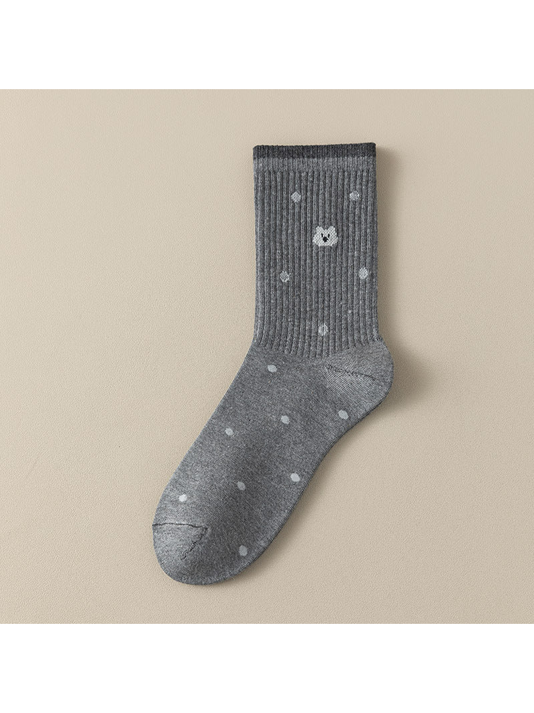 Cat crew sock with pale dots, a cat face motif and a dark cuff edge