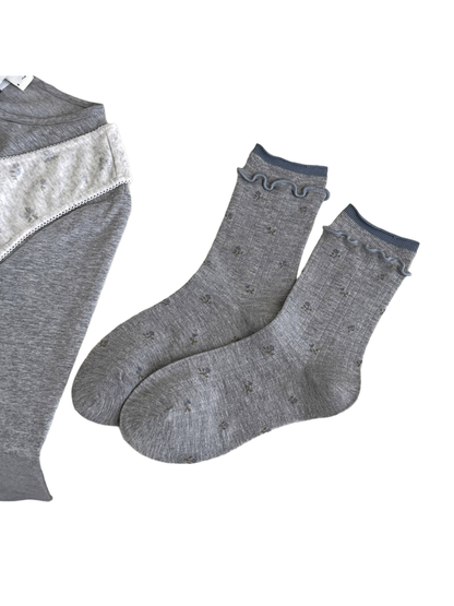 Heather Gray floral socks with blue cuff edging, vertical ribbing, and wavy trim