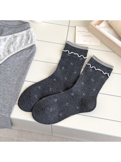 Dark Gray floral socks with light gray cuff edging, vertical ribbing, and white wavy trim