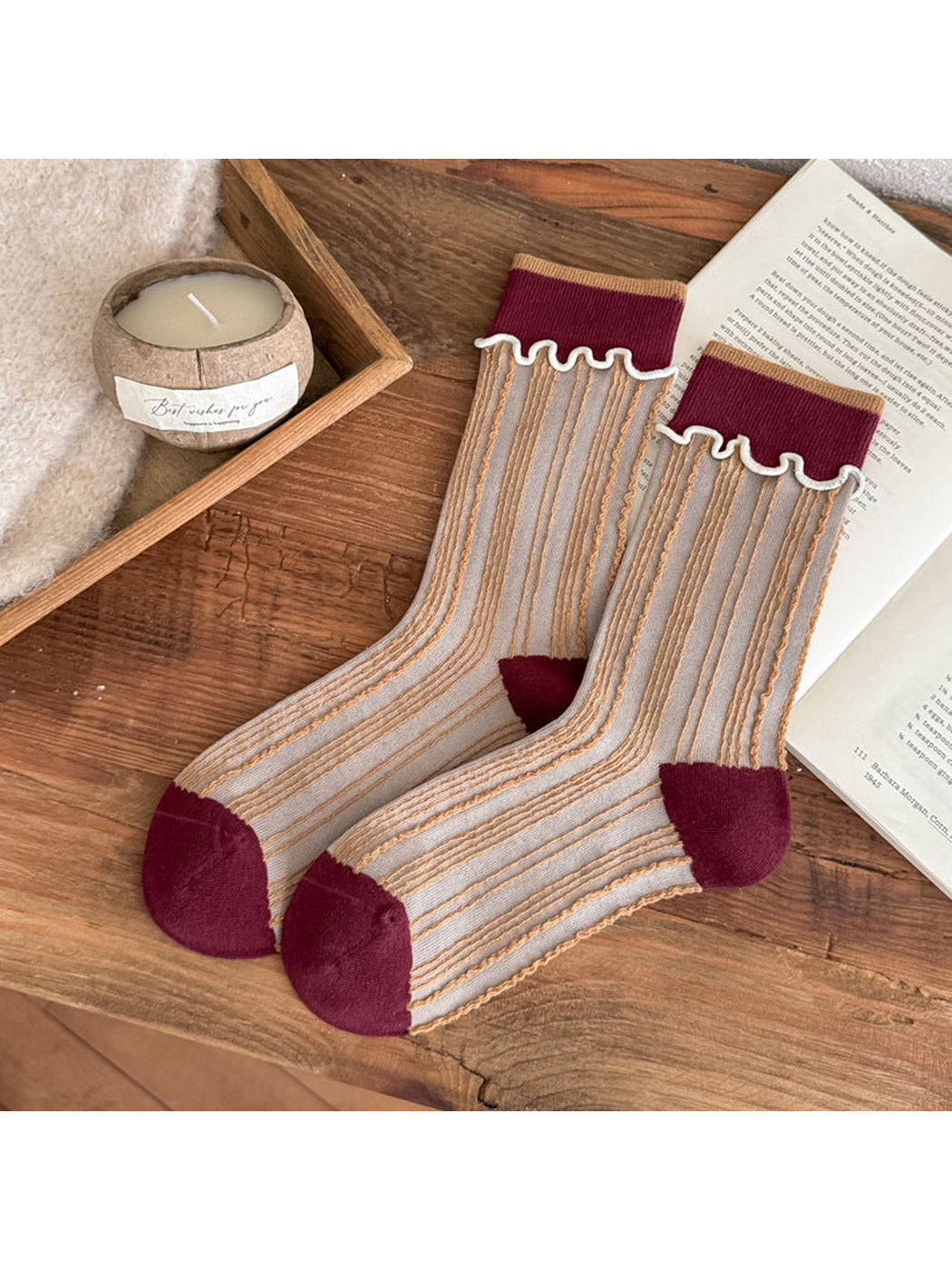 Burgundy socks with golden vertical stripes, contrasting toe and heel panels, and white wavy cuff trim