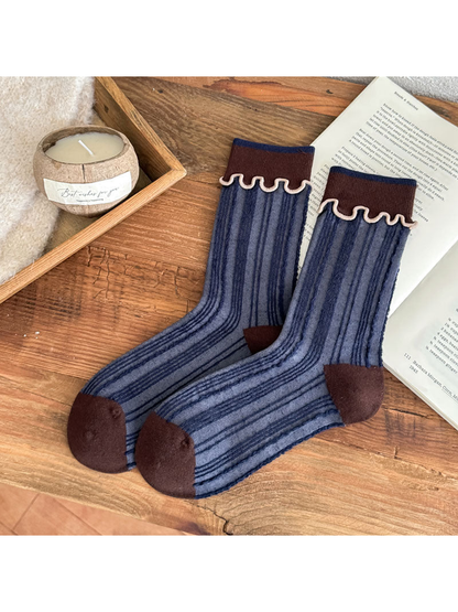 Blue striped socks with brown cuffs, toe and heel panels, and pale wavy cuff trim