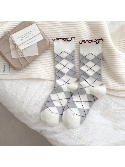 White socks with gray argyle diamonds and burgundy wavy cuffs
