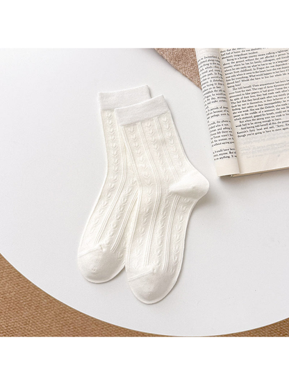 White Heart socks with repeating heart motifs, vertical ribbing, and straight cuffs.