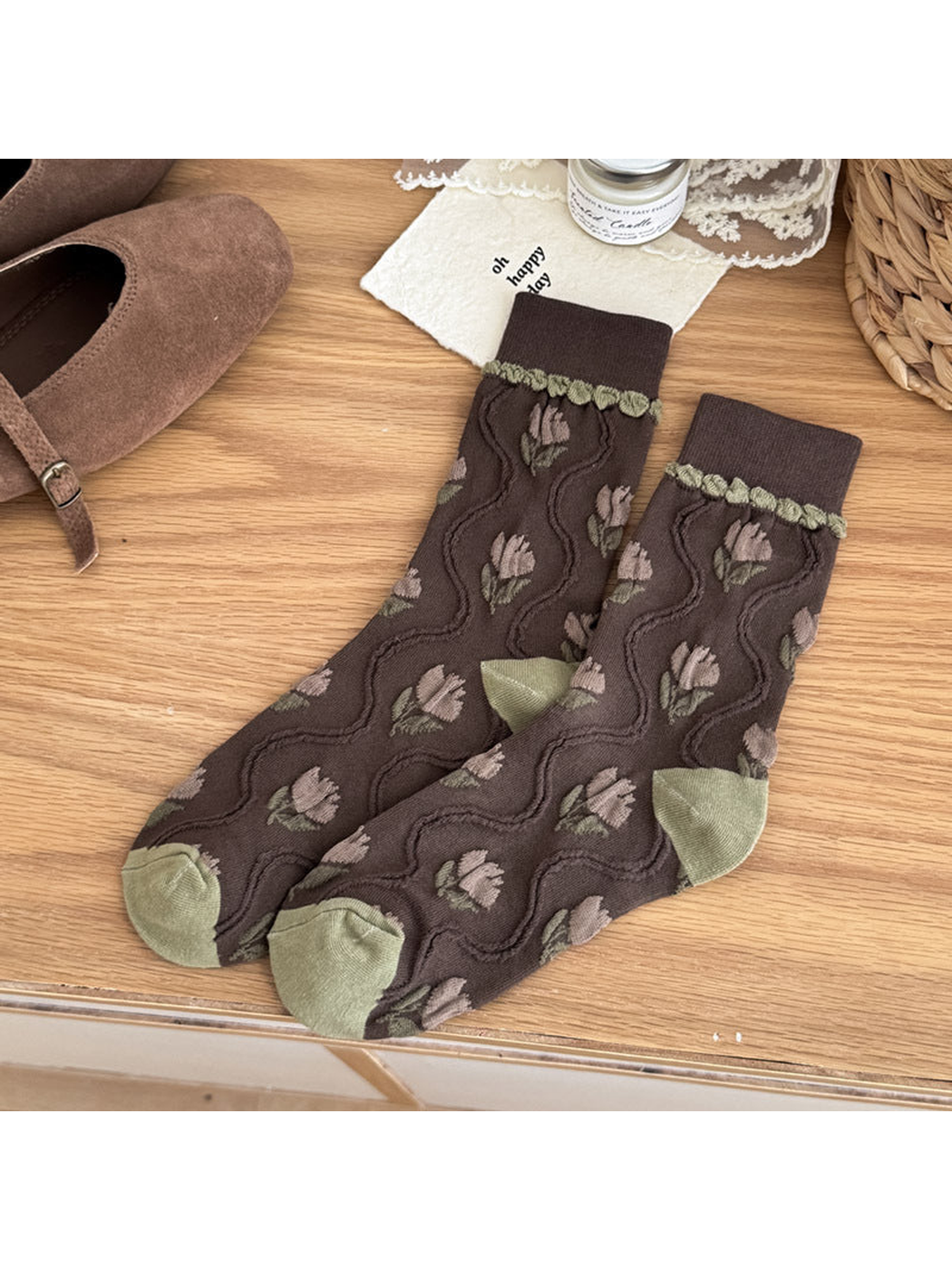 Coffee crew socks with taupe tulip motifs, raised wavy lines, and olive heel and toe panels.