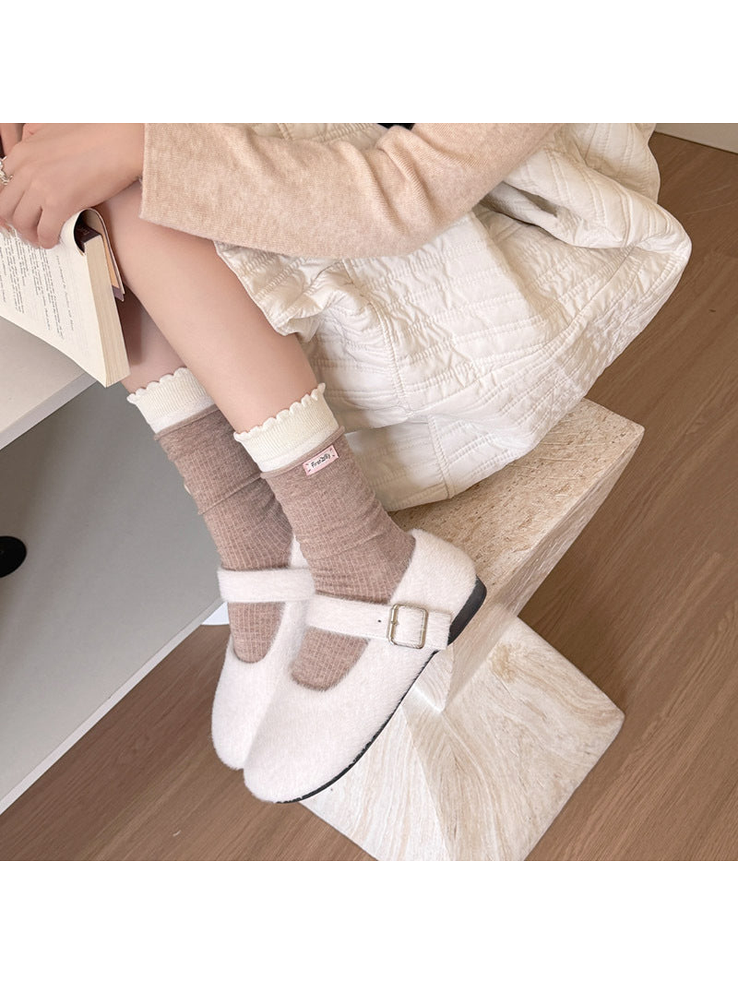 Beige ribbed socks with ivory scalloped cuffs worn with white buckle shoes