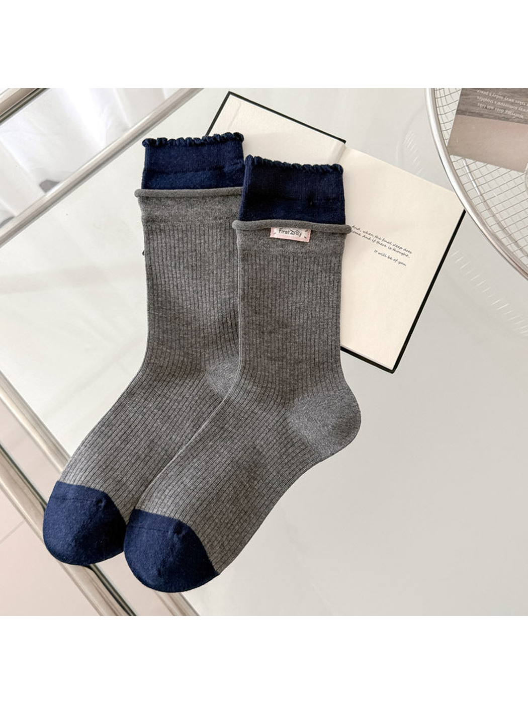 Gray ribbed socks with navy scalloped cuffs and contrasting navy toes