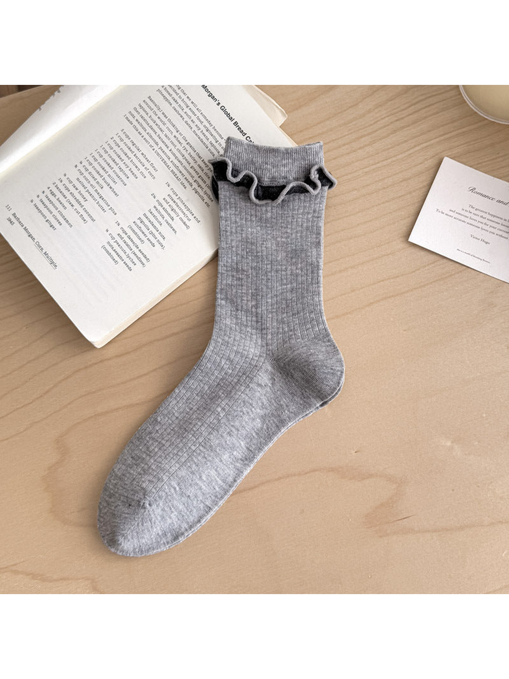 Heather Gray ribbed sock with contrasting dark ruffled trim below the cuff.