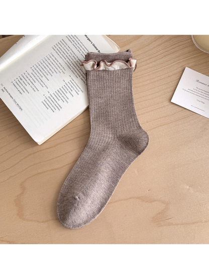 Light Coffee ribbed sock with contrasting pale ruffled trim below the cuff.